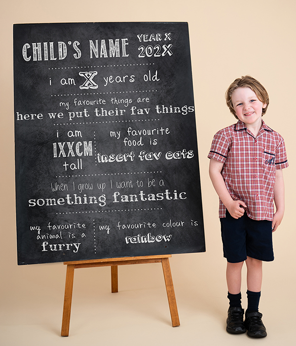 school boy with a chalkboard