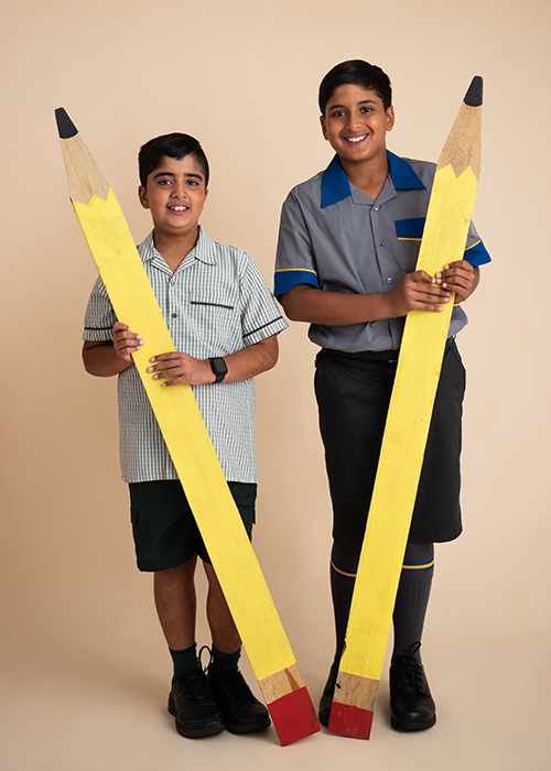 Brothers getting a back to school photos with pencils
