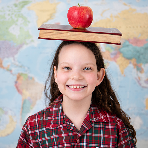 schoolgirl with book and apple