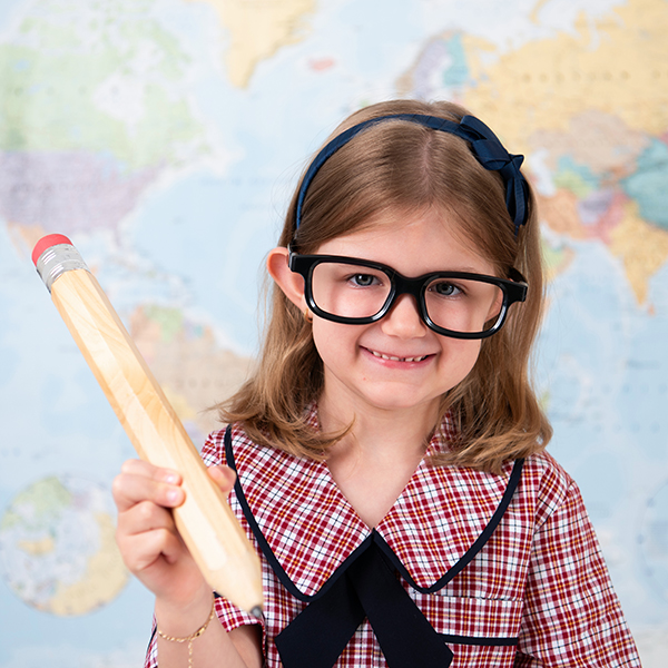 Student posing with pencil and glasses